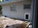 Exterior wall with windows and pet door at 5023 Inverness Dr, Sarasota, FL 34243