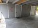 Carport with three storage doors and flamingo decor at 5023 Inverness Dr, Sarasota, FL 34243