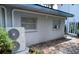 Exterior view of home with AC unit and landscaping at 5023 Inverness Dr, Sarasota, FL 34243