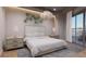 Bright bedroom with a king-size bed, nightstands, and access to a balcony at 1150 Windsong Ln # 200, Sarasota, FL 34242