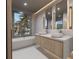Elegant bathroom with double sinks, soaking tub, and walk-in shower at 1150 Windsong Ln # 300, Sarasota, FL 34242