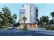 Modern building exterior with garage parking and palm trees at 1150 Windsong Ln # 300, Sarasota, FL 34242