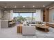 Open living room with modern sectional sofa, city view, and kitchen island at 1150 Windsong Ln # 300, Sarasota, FL 34242