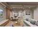 Open concept living room with modern furniture, hardwood floors, and large TV at 1150 Windsong Ln # 300, Sarasota, FL 34242