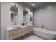 Elegant bathroom featuring a freestanding tub and double sinks at 1150 Windsong Ln # 400, Sarasota, FL 34242