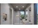 Spa-like bathroom with double sinks, soaking tub, and marble finishes at 1150 Windsong Ln # 400, Sarasota, FL 34242