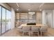 Modern dining area with built-in shelving and a wood dining table at 1150 Windsong Ln # 400, Sarasota, FL 34242