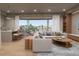 Open-concept living space with a sectional sofa, modern fireplace, and access to a balcony at 1150 Windsong Ln # 200, Sarasota, FL 34242