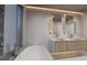 Elegant bathroom with double vanity, large mirrors, and free-standing tub at 1150 Windsong Ln # 200, Sarasota, FL 34242