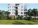 Modern building with a garage and lush landscaping at 1150 Windsong Ln # 300, Sarasota, FL 34242
