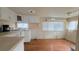 Features include wood floors, white cabinets, a kitchen sink, and a window at 10315 Cortez W Rd # 55-2, Bradenton, FL 34210