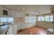 Bright kitchen featuring wood floors, a sink, and white cabinets with natural light from windows at 10315 Cortez W Rd # 55-2, Bradenton, FL 34210