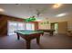 Community game room featuring two pool tables under hanging lights at 2611 Pine Lake Ter # B, Sarasota, FL 34237