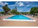 Community pool on a sunny day with lounge chairs and clear blue water at 2611 Pine Lake Ter # B, Sarasota, FL 34237