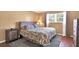 Cozy bedroom with hardwood floors, a comfortable bed, and a serene ambiance for relaxation at 4440 Ironwood Cir # 108D, Bradenton, FL 34209