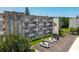 Exterior view of building featuring well-maintained landscaping and ample parking space at 4440 Ironwood Cir # 108D, Bradenton, FL 34209