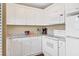 Bright kitchen featuring white cabinetry, granite countertops, and modern appliances, perfect for cooking and entertaining at 4440 Ironwood Cir # 108D, Bradenton, FL 34209