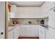 Bright kitchen features white cabinets, granite countertops, and modern appliances at 4440 Ironwood Cir # 108D, Bradenton, FL 34209