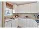 Well-lit kitchen boasts white cabinets and granite countertops with updated appliances at 4440 Ironwood Cir # 108D, Bradenton, FL 34209