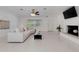 Open living room with fireplace, neutral furniture, and ample natural light at 701 Armada S Rd, Venice, FL 34285
