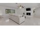 Open living room with fireplace, neutral furniture, and ample natural light at 701 Armada S Rd, Venice, FL 34285
