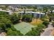 Aerial view of tennis courts nestled within a lush green community at 4440 Ironwood Cir # 108D, Bradenton, FL 34209