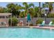 Relaxing pool area with lounge chairs and patio umbrella at 4440 Ironwood Cir # 108D, Bradenton, FL 34209