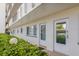 Condo building exterior hallway with lush green landscaping at 4440 Ironwood Cir # 108D, Bradenton, FL 34209