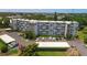 Aerial view of condo building with parking and landscaping at 4440 Ironwood Cir # 108D, Bradenton, FL 34209