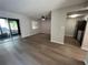Spacious living room with wood-look floors and sliding glass doors at 2611 Pine Lake Ter # B, Sarasota, FL 34237