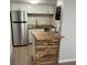 Updated kitchen with stainless steel refrigerator and butcher block island at 2611 Pine Lake Ter # B, Sarasota, FL 34237