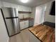 Modern kitchen with stainless steel appliances and butcher block counters at 2611 Pine Lake Ter # B, Sarasota, FL 34237