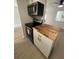 Modern kitchen features butcher block countertops and stainless steel appliances at 2611 Pine Lake Ter # B, Sarasota, FL 34237