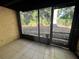 Bright Florida room with view of backyard and trees at 2611 Pine Lake Ter # B, Sarasota, FL 34237
