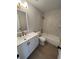 Updated bathroom with white vanity, marble tile, and bathtub at 2611 Pine Lake Ter # B, Sarasota, FL 34237