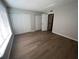 Well-lit bedroom featuring wood-look flooring and double closets at 2611 Pine Lake Ter # B, Sarasota, FL 34237