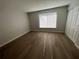Spacious bedroom with wood-look floors and large window at 2611 Pine Lake Ter # B, Sarasota, FL 34237