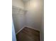 Walk-in closet with wire shelving and wood-look flooring at 2611 Pine Lake Ter # B, Sarasota, FL 34237