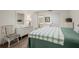 Bedroom with a dresser, chair, and a view of the bathroom at 4560 Forest Wood Trl # 16, Sarasota, FL 34241