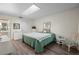 Bedroom with wood-look floors, dresser and a comfortable bed at 4560 Forest Wood Trl # 16, Sarasota, FL 34241