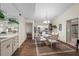 Elegant dining room with glass table and white chairs at 4560 Forest Wood Trl # 16, Sarasota, FL 34241
