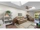 Living area with leather couches, wood-look floors, and a view to patio at 4560 Forest Wood Trl # 16, Sarasota, FL 34241