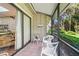 Relaxing screened porch with table and chairs, lush view at 4560 Forest Wood Trl # 16, Sarasota, FL 34241