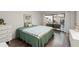 Green bedroom with a view of the living room and access to patio at 4560 Forest Wood Trl # 16, Sarasota, FL 34241