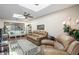 Spacious living room featuring a comfy leather couch and a view of the bedroom at 4560 Forest Wood Trl # 16, Sarasota, FL 34241