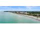 Aerial view of a long stretch of beach with turquoise water at 701 Armada S Rd, Venice, FL 34285