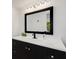 Bathroom with a vanity, mirror, and dark cabinets at 701 Armada S Rd, Venice, FL 34285