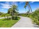 House exterior with a circular driveway and tropical landscaping at 701 Armada S Rd, Venice, FL 34285