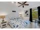 Bedroom with coastal bedding, ceiling fan, and ocean-themed art at 701 Armada S Rd, Venice, FL 34285