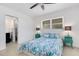 Bedroom with full bed, teal nightstands, and access to a bathroom at 701 Armada S Rd, Venice, FL 34285